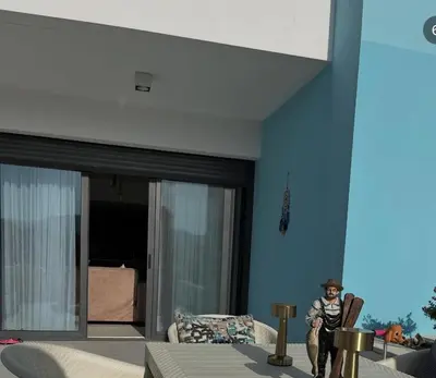 a person standing in a living room in a house at Seaside Luxury Apartment with Terrace and BBQ in Aqaba