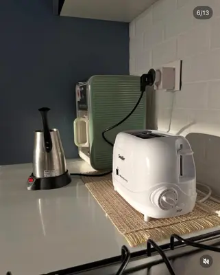 a toaster sitting on top of a kitchen counter at Seaside Luxury Apartment with Terrace and BBQ in Aqaba
