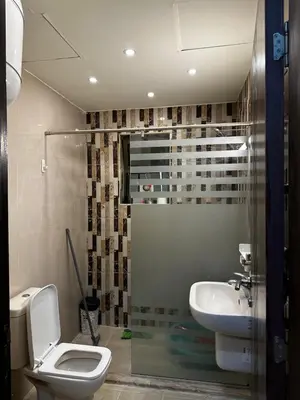 a bathroom with a toilet and a sink at شقة بالرابية in Amman