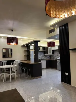 a large kitchen with a island in the middle at شقة بالرابية in Amman