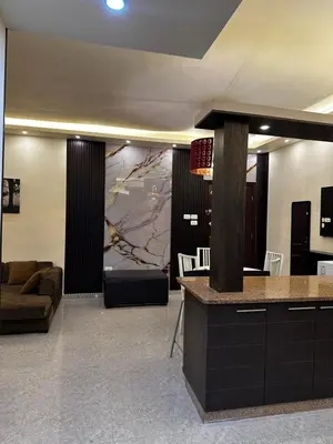 a living room with a couch and a table at شقة بالرابية in Amman