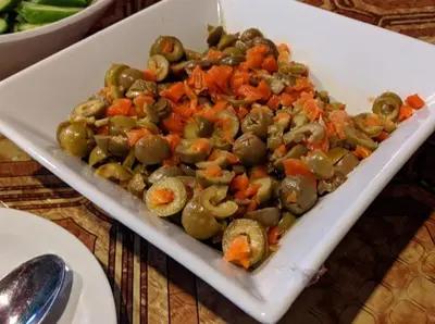 a white plate of vegetables on a table at Rocky Mountain Hotel Jordan in Petra
