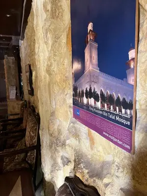 a sign on a wall with a picture of a building at Rocky Mountain Hotel Jordan in Petra