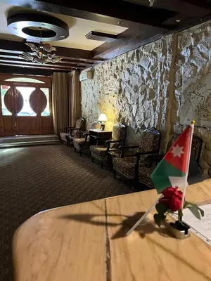 a room with a table with a flag on it at Rocky Mountain Hotel Jordan in Petra