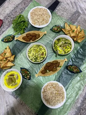 a table with plates of food on a table at Kirakoupdolis house & restaurant in Kerak