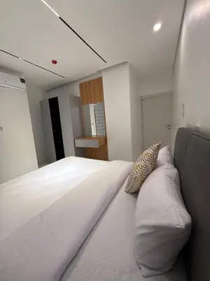 a bedroom with a large white bed with pillows at ريڨا للأجنحة السكنية Riva suites in Irbid