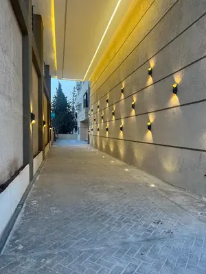 an empty hallway with lights on the side of a building at ريڨا للأجنحة السكنية Riva suites in Irbid
