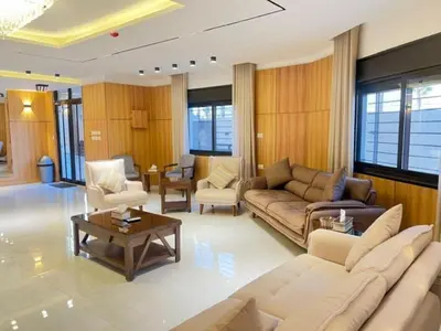 a living room with a couch and a table at ريڨا للأجنحة السكنية Riva suites in Irbid