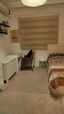 a bedroom with a bed and a desk and a chair at حي الجامعة خلف الجامعة الاردنية in Amman