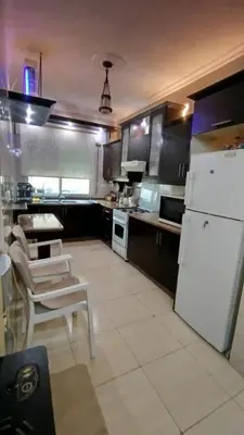 a kitchen with a white refrigerator and white appliances at حي الجامعة خلف الجامعة الاردنية in Amman