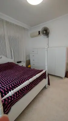 a bedroom with a bed with a purple comforter at حي الجامعة خلف الجامعة الاردنية in Amman