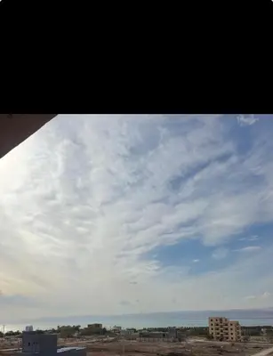 a view of a cloudy sky from a building at Seaview horizon apartment in Sowayma