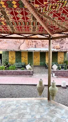 a patio with three vases sitting under a pavilion at Wadi Rum Desert Memory in Wadi Rum