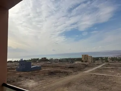 a view of a construction site with the ocean in the background at panorama sea view apartment in Sowayma