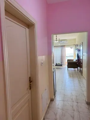 a hallway with a door and a living room at panorama sea view apartment in Sowayma