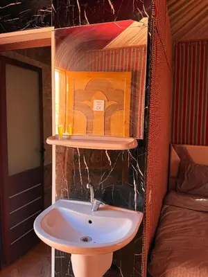 a bathroom with a sink in a room at Desert Moon Camp in Wadi Rum