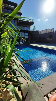 a pool with blue water in front of a building at LP chalet deadSea view in Sowayma