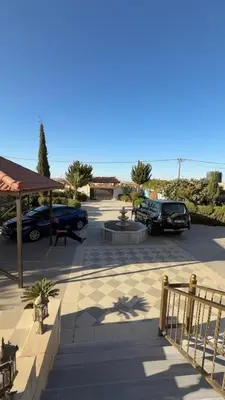 a parking lot with cars parked in front of the beach at Villa Qsai alnerat in Riḩāb