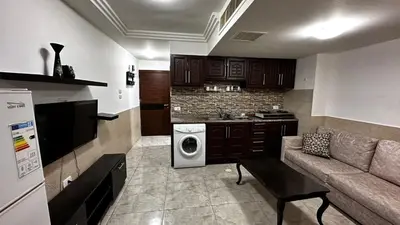 a living room with a couch and a kitchen at 1 bedroom Studio in 7th circle area in Amman