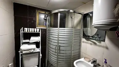 a small bathroom with a shower and a sink at 1 bedroom Studio in 7th circle area in Amman
