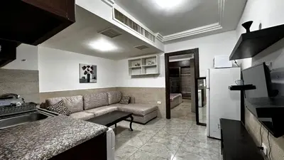 a kitchen and living room with a couch and a refrigerator at 1 bedroom Studio in 7th circle area in Amman