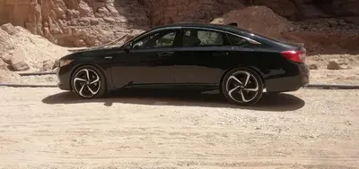 a black car parked on a dirt road at سياره ليموزين in Amman