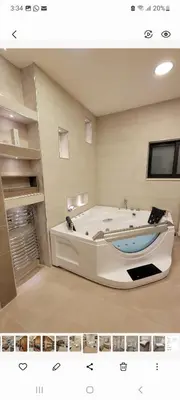 a large bathroom with a tub in a room at Lavender Résidence 102 in Amman