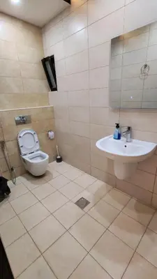 a bathroom with a toilet and a sink at La Perla Apertment Family in Amman