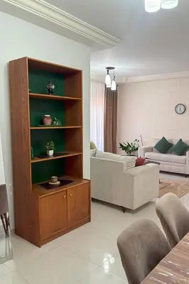 a living room with a couch and a table at Comfy Apt at Jandawil -only Families- in Amman