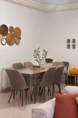 a dining room with a wooden table and chairs at Comfy Apt at Jandawil -only Families- in Amman