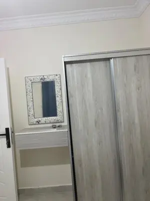 a mirror on a wall next to a door at الحمد للاجنحة الفندقية in Aqaba