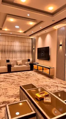 a large living room with a couch and a tv at شقق فندقيه فخمه للايجار اليومي in Ash Shumaysānī