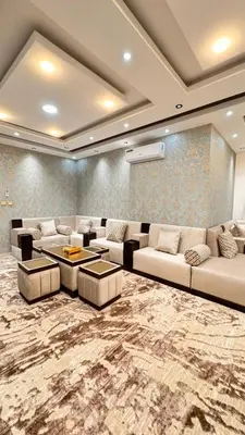 a large living room with couches and a rug at شقق فندقيه فخمه للايجار اليومي in Ash Shumaysānī