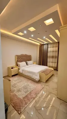 a bedroom with a large bed and a rug at شقق فندقيه فخمه للايجار اليومي in Ash Shumaysānī