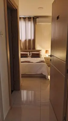 a small bedroom with a bed and a window at hotel amman in Amman