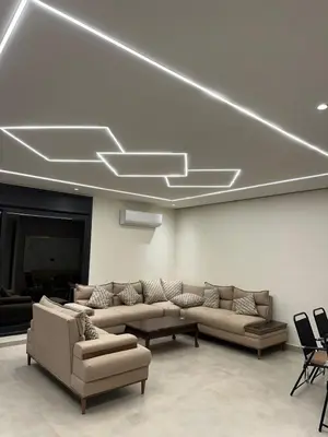 a living room with couches and a couch and a table at شاليه الدرة Durra Chalet in Amman