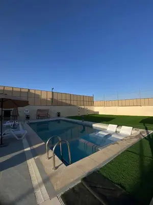 a large swimming pool in front of a building at شاليه الدرة Durra Chalet in Amman