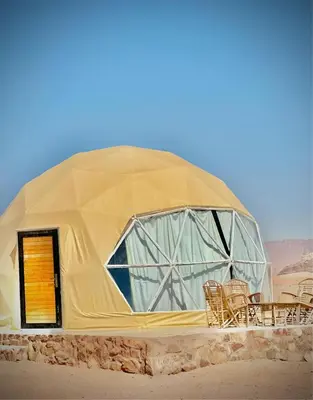 a dome tent with chairs and tables in the desert at Mohammad rum camp in Disah