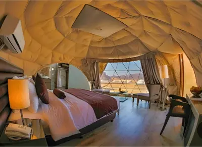 a bedroom with a large bed in a tent at Mohammad rum camp in Disah