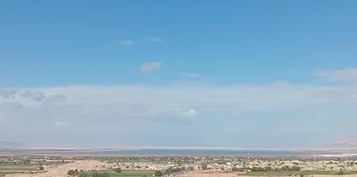 a view of the desert with a blue sky at Panoramic GUESTHOUSE - OUM ALI in Aş Şāfī