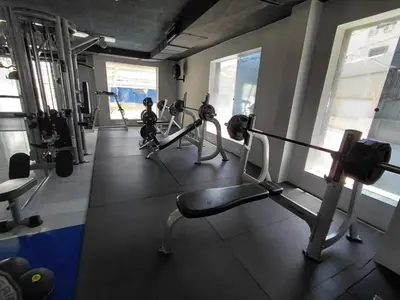 a gym with several tread machines in a room at Badan Suites & Hotel in Amman