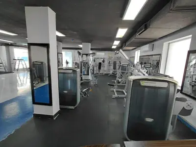 a gym with a row of urinals and machines at Badan Suites & Hotel in Amman
