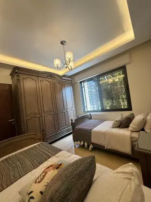 a bedroom with two beds and a window at مطر in Amman