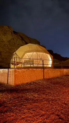 a large domed building in a field at night at Nile bedouin camp in Aqaba