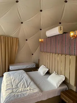 a bedroom with two beds in a tent at Nile bedouin camp in Aqaba