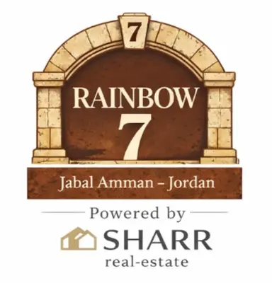 a sign that reads rainbow powered by a stone arch at Rainbow 7 in Amman