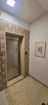 a room with a glass door and a brick wall at Rainbow 7 in Amman