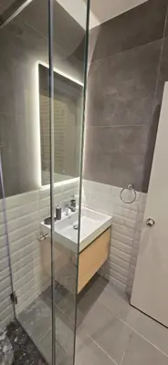 a bathroom with a sink and a shower at Rainbow 7 in Amman