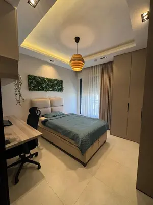 a bedroom with a bed and a desk in it at The FWD Living - FWD2 in Amman