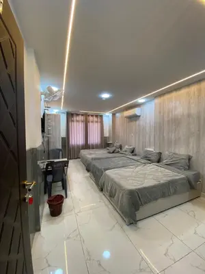 a bedroom with a large bed and a desk at Avatar Hotel-Aqaba in Aqaba